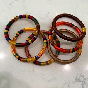 Six multicolored silk threaded bracelets.